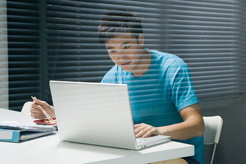 Man on laptop with takeaway