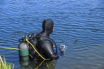 Scuba diver entering lake