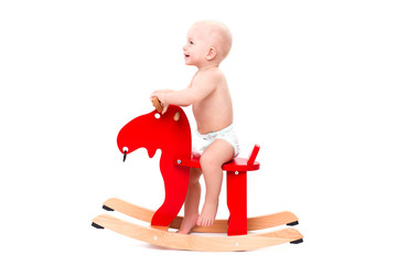 Baby on the toy horse or elk
