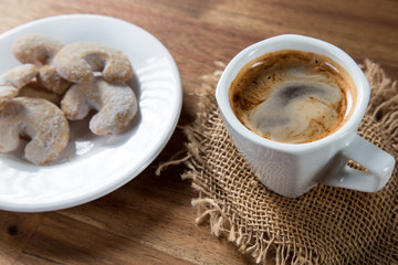 Christmas sweet rolls with coffee on brown wooden background.