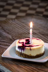 huckleberry cheesecake with a candle