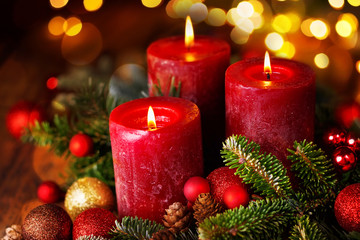Obraz na płótnie Canvas Three burning candles in festive christmas arrangement, 3. Advent
