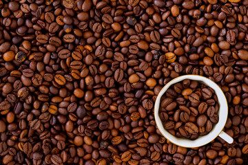 Daily dose coffee. А cup of coffee with coffee beans. Beans background.