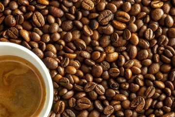 A cup of coffee with beans as background.
