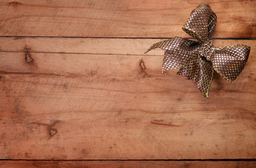 Vintage wooden background with Golden bow