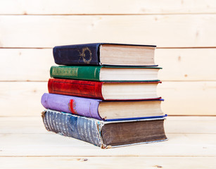 Old books on a wooden shelf.