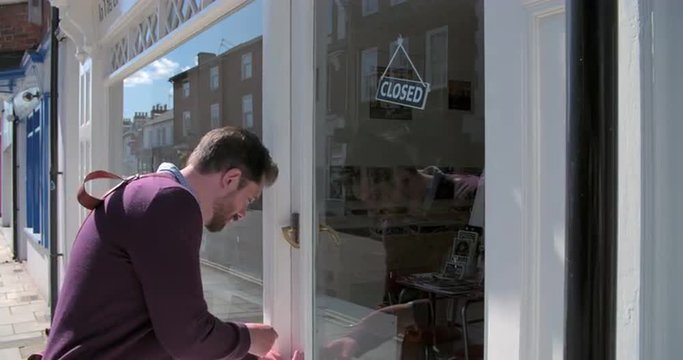 Shop owner opening up record, CD and hi-fi shop