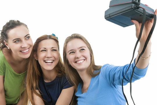 Three Young Happy caucasian Females With Photocamera Taking Selfie Photos