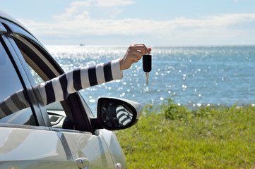 Women showing car keys out window
