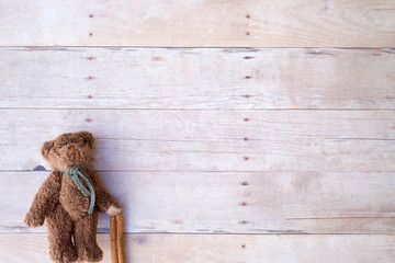 teddy bear ornaments on a wood background.