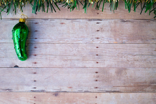 Glass Pickle Ornament On A Wood Background.