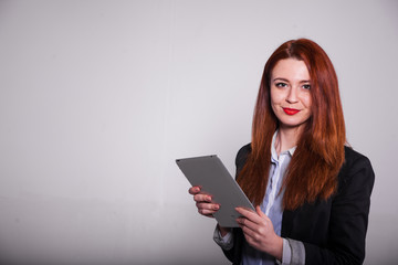 red businesswoman showing tablet isolated over white