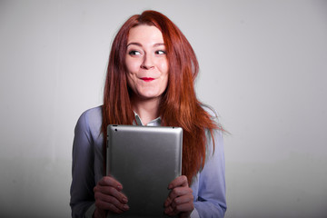 Happy woman with red hair and tablet