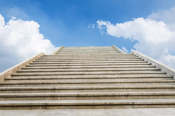 concrete staircase going up into a blue sky