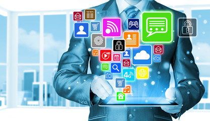 Obraz premium Business man using tablet PC with social media icon set