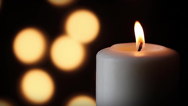 Loop - White Candle with Lights in the Soft-focused Background