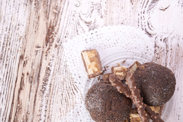 Cupcake with chocolate on wooden background