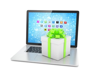 Gift box with ribbon bow on laptop keyboard