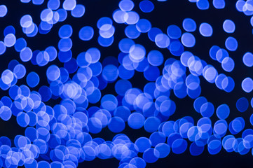 Many blue bokeh lights on dark background