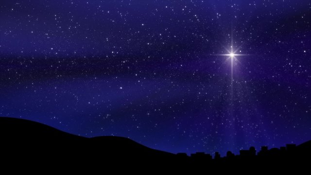 A large Christmas Nativity Star shines down on Bethlehem silhouetted by a midnight blue cloudy motion background sky. Loop is perfectly seamless (no fade).