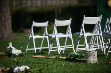 rows of white chairs arranged for a wedding ceremony