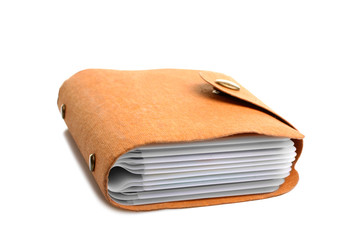 enclosed business card holder, back cover made of natural material, lies on a white isolated background