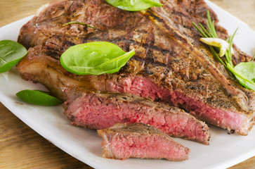 Steak served with fresh green salad.