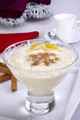 Cup of rice pudding with cinnamon and lemon peel