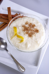 Cup of rice pudding with cinnamon and lemon peel