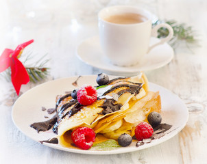 Christmas breakfast. Coffee and Crepes with fresh berries.