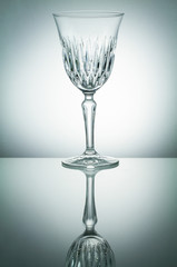 Crystal  glass with reflection on white illuminated background