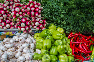  Red and green peppers, parsley and dill,  radish  and  garlic  on the counter market