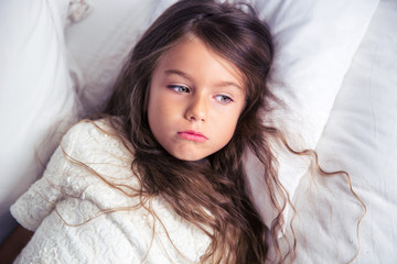 Little girl resting in bed