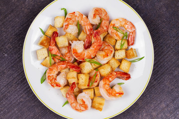 Shrimp with crispy croutons and scallions. View from above, top studio shot