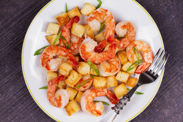 Shrimp with crispy croutons and scallions. View from above, top studio shot