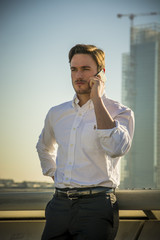 Handsome trendy man talkiing on cell phone, outdoor