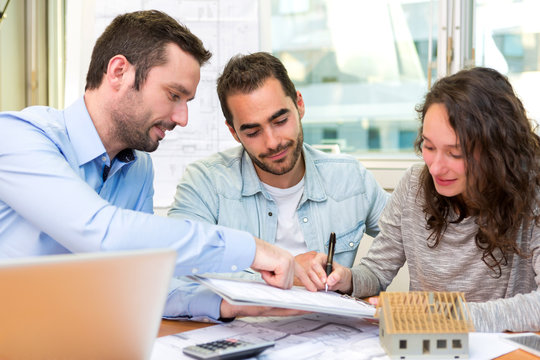 Young attractive people signing cotract with meeting real estate