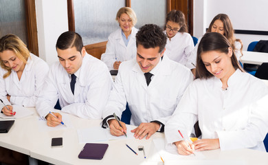 Multinational interns and professor having discussion