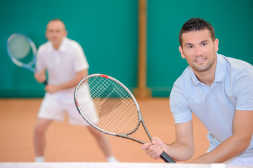 Two men poised for a game of tennis