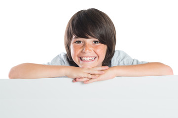 Happy boy behind board