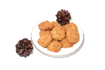 Cookies and fir cones on white background