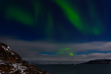 Fototapeta na wymiar Green aurora over the Arctic Ocean