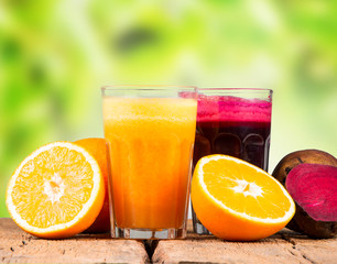 Fresh juice, mix fruits and vegetable, carrot, beetroot and orange drinks on wooden table. 