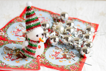 Selective focus of little snowman with Christmas decorations