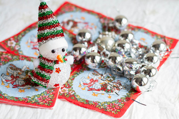 Selective focus of little snowman with Christmas decorations