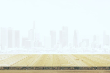 Table from beige wood at city background