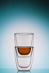 glass cups of tea, shooting against the light with a color gradient