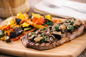 Grilled beefsteak with mushrooms and mixed vegetables.