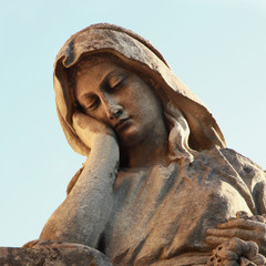 Statue of woman on tomb as a symbol of depression and sorrow
