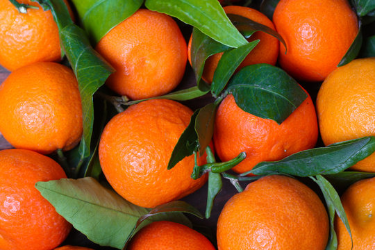 background Bunch of fresh tangerines oranges on market